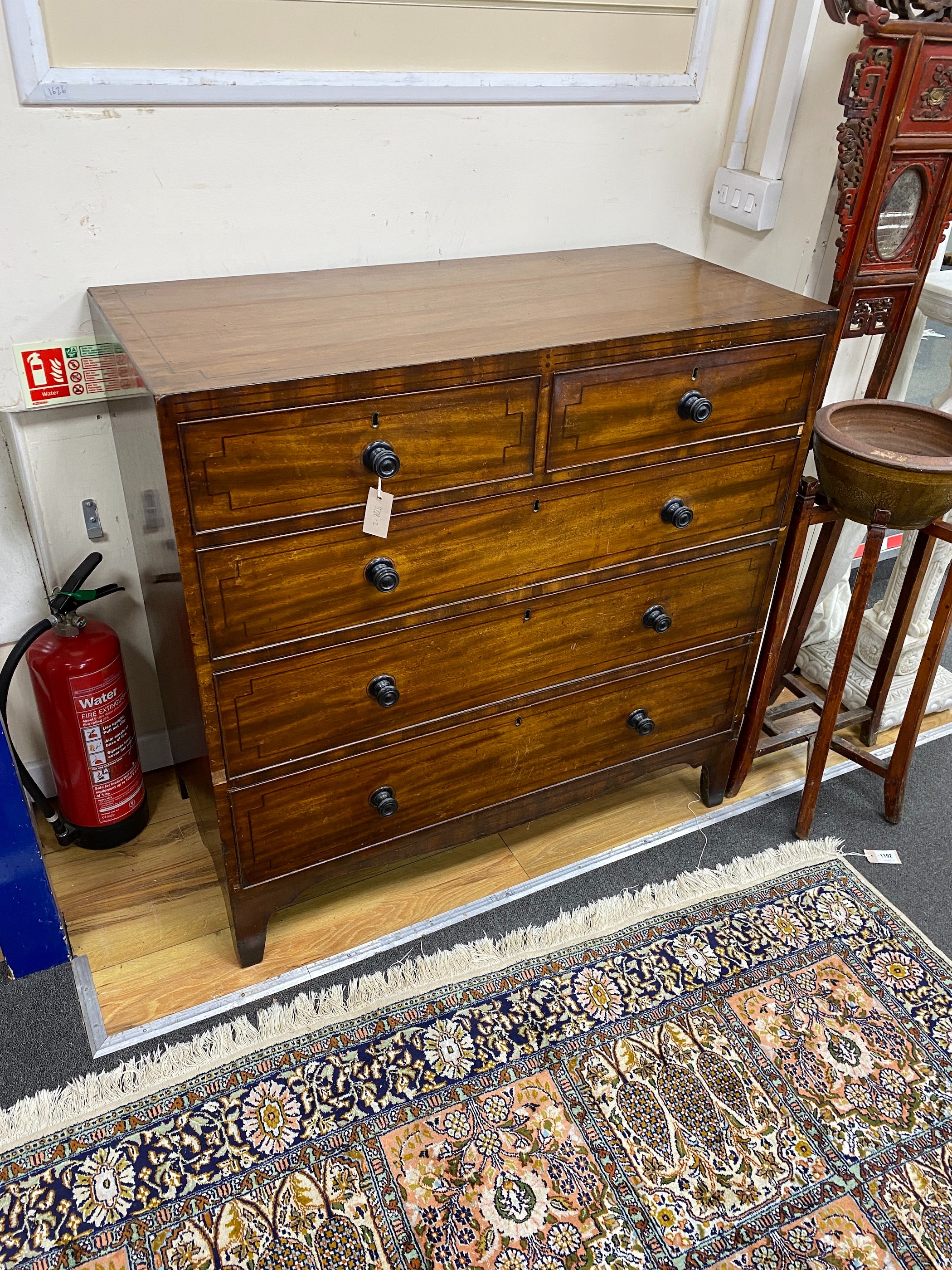 A George IV strung inlaid mahogany chest of two short and three long drawers, width 107cm, depth 50cm, height 106cm